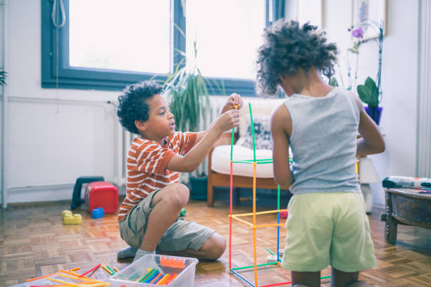 istock Cute mixed - race siblings playing at home 974797296