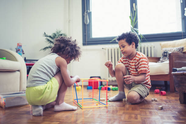 istock Cute mixed - race siblings playing at home 974797310