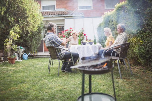 istock Senior people, friends having fun, enjoying backyard barbecue 974807016