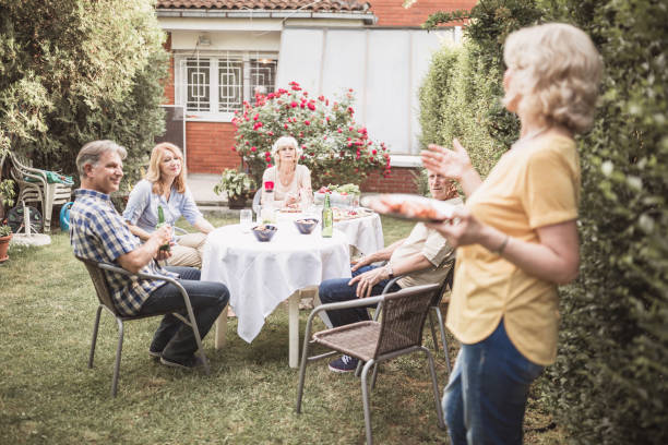 istock Senior people, friends having fun, enjoying backyard barbecue 974807104