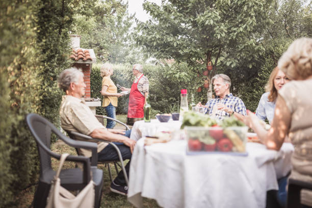 istock Senior people, friends having fun, enjoying backyard barbecue 974807206