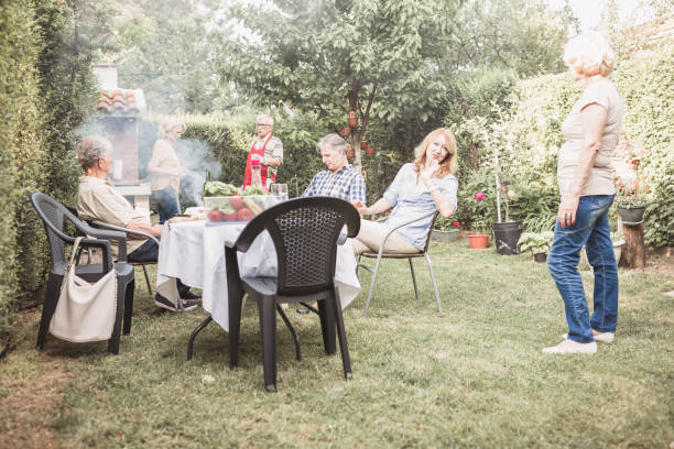 istock Senior people, friends having fun, enjoying backyard barbecue 974807278