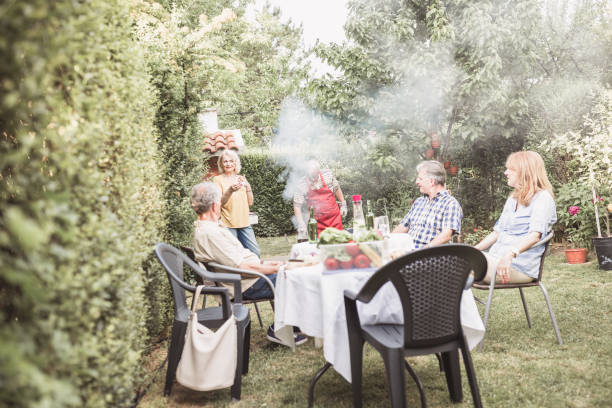 istock Senior people, friends having fun, enjoying backyard barbecue 974807744