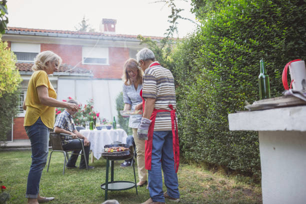 istock Senior people, friends having fun, enjoying backyard barbecue 974809332