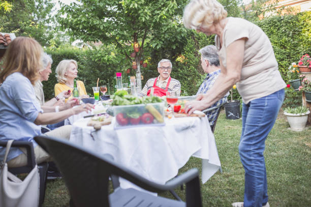 istock Senior people, friends having fun, enjoying backyard barbecue 974811594