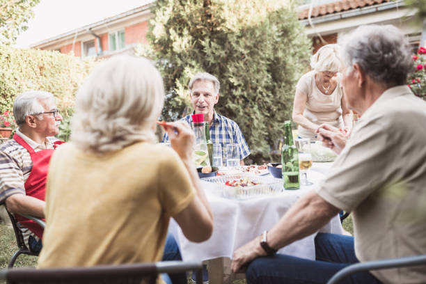 istock Senior people, friends having fun, enjoying backyard barbecue 974811644