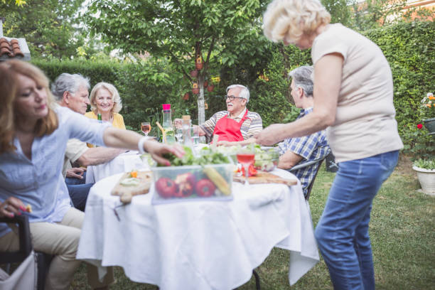 istock Senior people, friends having fun, enjoying backyard barbecue 974811694