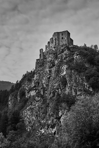 The ruins of medieval Strecno castle near Zilina in Slovakia in black and white.