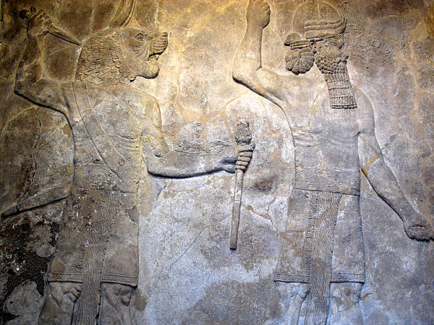 Ancient Assyrian relief 700-692 BC from the Nineveh Palace showing a pair of protective spirits.