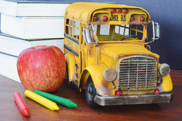 istock Books, apple, crayons and student bus 974812996