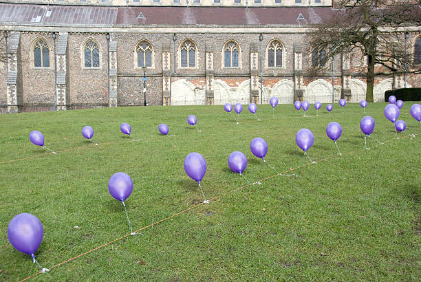 Purple Balloons with Line Tied On Ground stock photo