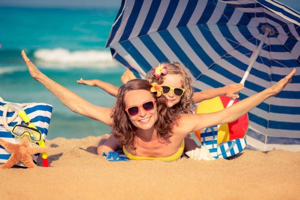 istock Child amd mother on the beach 974815688