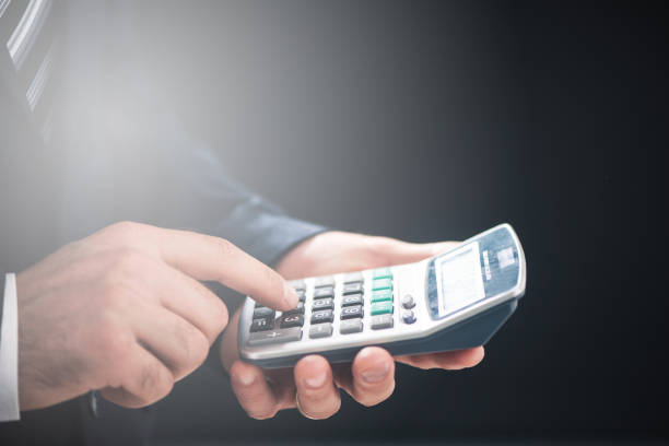 istock Closeup image of a business man using calculator 974820072