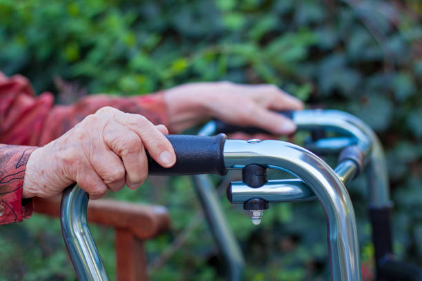 istock Elderly woman handing with two hands a walker 974820716