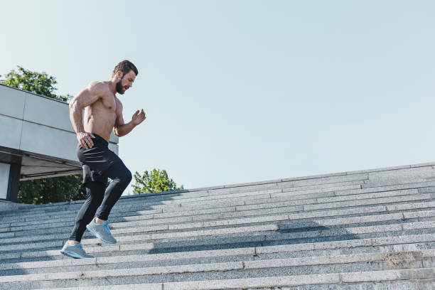 istock Fit man doing exercises outdoors at city 974821038
