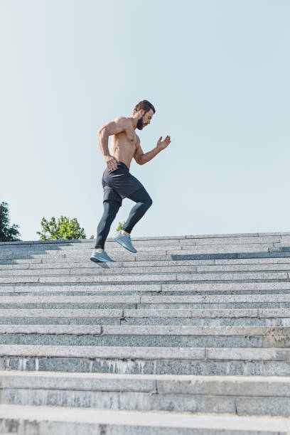 istock Fit man doing exercises outdoors at city 974821208