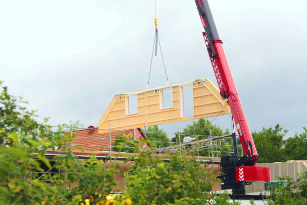 assembly of a prefab house, crane lifting gable component assembly of a prefabricated timber house, crane lifting a gable component in the air prefabricated building stock pictures, royalty-free photos & images
