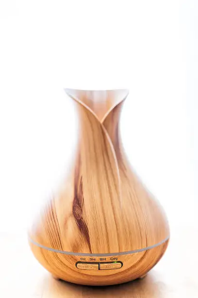 Wooden bamboo essential oil diffuser vertical closeup, with buttons timer, steam modern minimalistic minimal health vapor