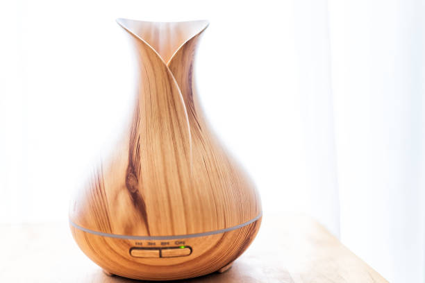 istock Wooden bamboo essential oil diffuser closeup, with buttons timer, steam modern minimalistic minimal health vapor 974832092