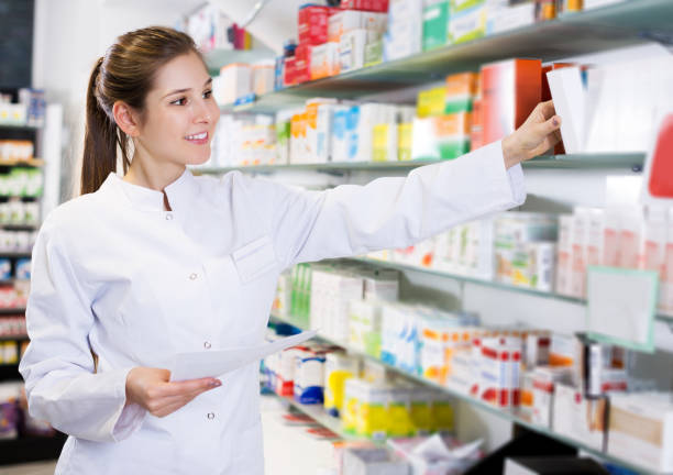 istock pharmacist is searching medicine on shelves 974837494