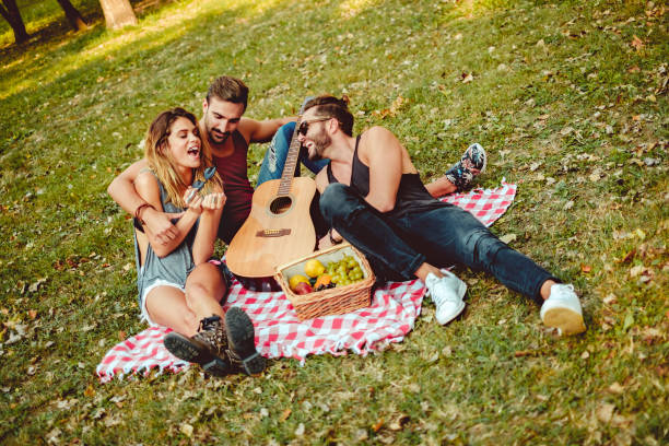 istock Friends hugging and smiling on a picnic 974849216