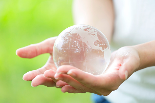 Women's hand with transparent globe