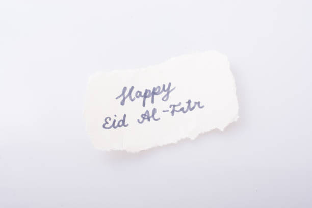 istock the word EID EL FITR  written on torn paper 974858852