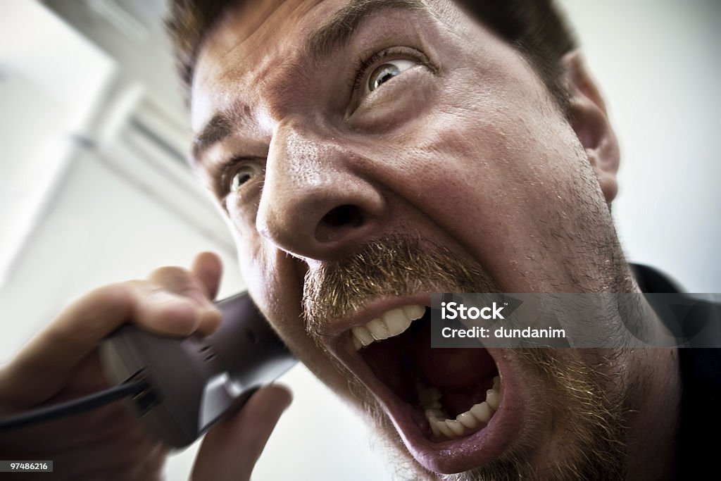 Man shouting at telephone  Telephone Stock Photo