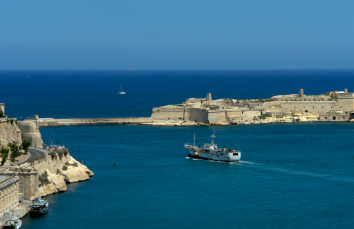 Valetta, Malta - June 6, 2023: Luxury boats moored alongside Fort Saint Angelo in Grand Harbour, Valetta, Malta