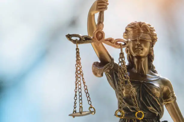 Lady Justice or Justicia in front of blurred background. The roman goddess of justice.