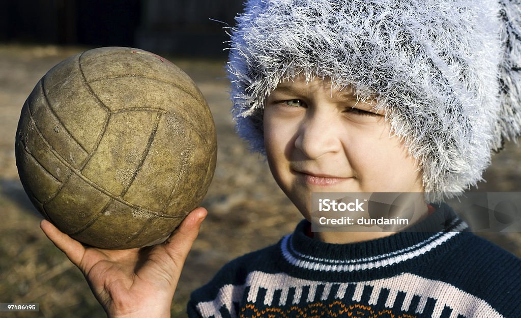 Needy boy with warn ball in his hand  Beautiful People Stock Photo