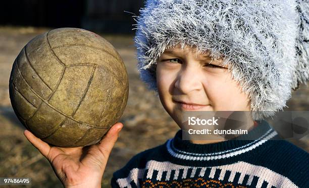 Needy Boy With Warn Ball In His Hand Stock Photo - Download Image Now - Beautiful People, Boys, Cap - Hat