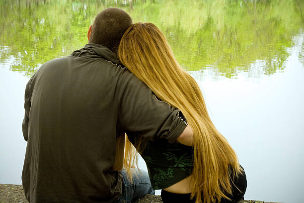 Lovers on lakeside stock photo