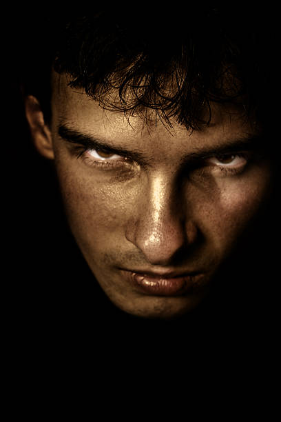 Scary face in the shadow stock photo