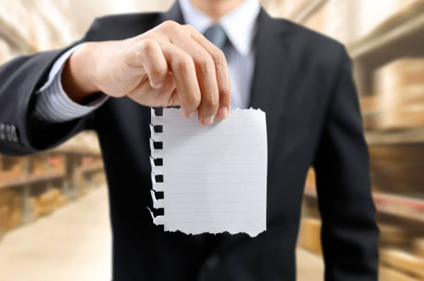 istock businessman show task list on notepad with warehouse background 974867696