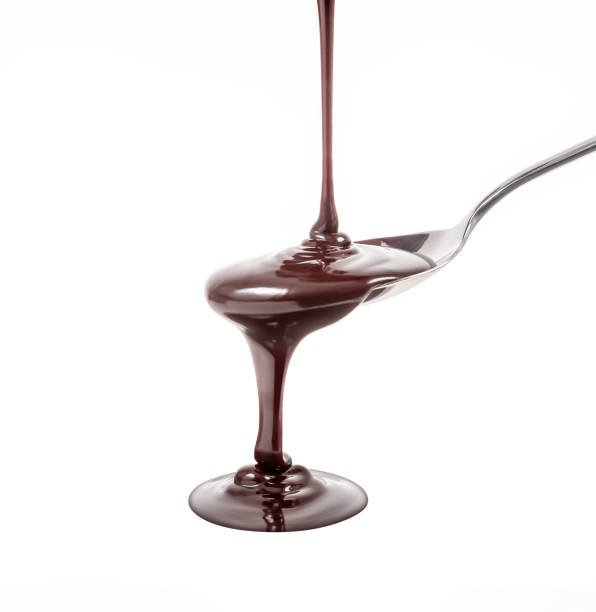 istock chocolate syrup pouring on spoon, cooking, baking 974867784