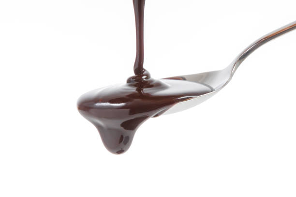 istock chocolate syrup pouring on spoon, cooking, baking 974867802