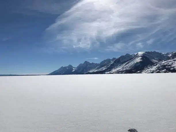 Jackson Lake in Grand Teton National Park covered in snow.