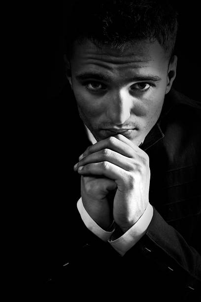 istock Sad man in the dark praying to God 97486875