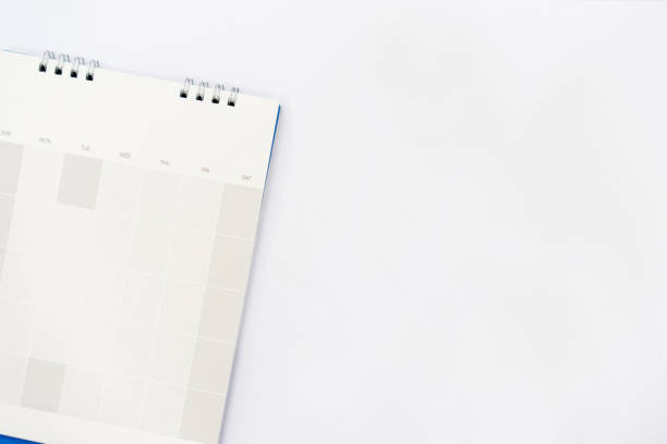 istock close up on white calendar with empty schedule lay on bright  background for mock up design concept 974868990