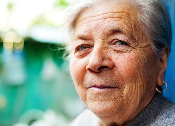 Smile of one content happy senior woman stock photo