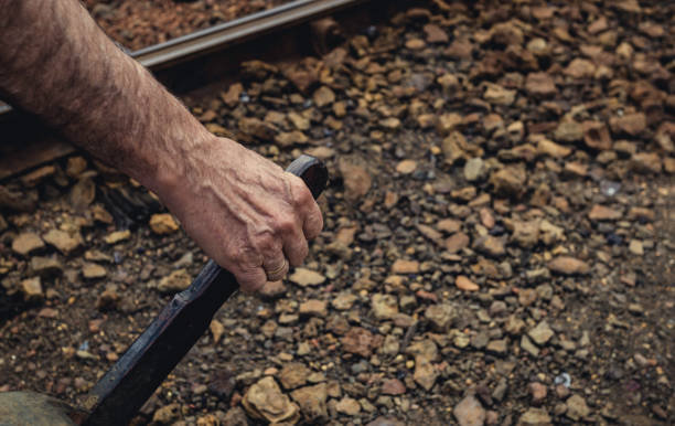 mão com anel de ouro agarrando a alavanca para mudar a trilha do trem na estação de trem antigo - throwing stone human hand rock - fotografias e filmes do acervo