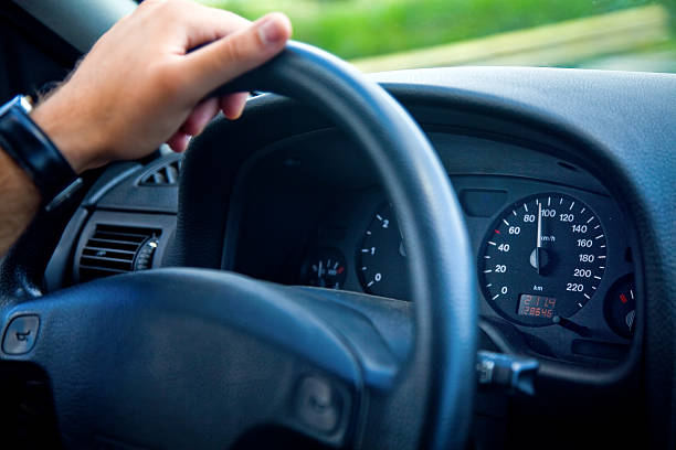 istock Male driver with hand on wheel inside car 97487307