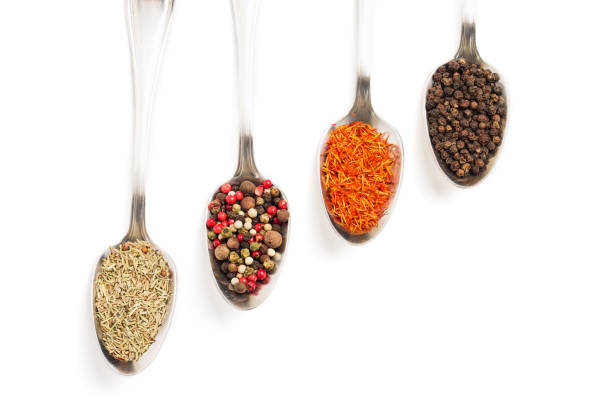 istock Different spices in iron spoons isolated on white 974873950