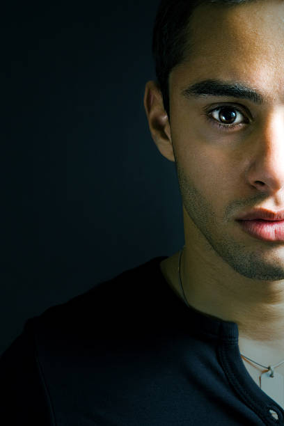 istock Half face portrait of one serious young man 97487462