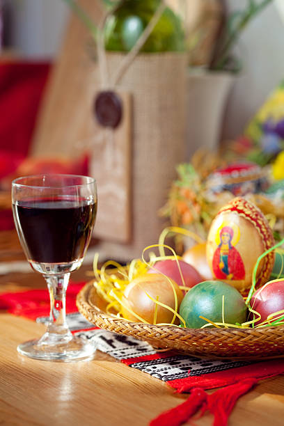 Easter painted eggs and wine glass on table stock photo