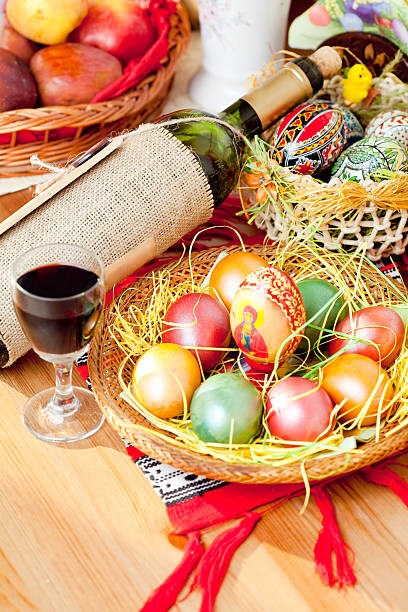 Easter painted eggs with wine bottle and glass stock photo