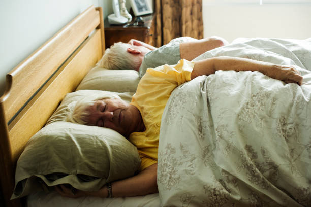 istock Elderly caucasian couple sleeping on the bed 974882344