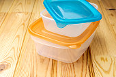 Plastic food containers on a wooden table