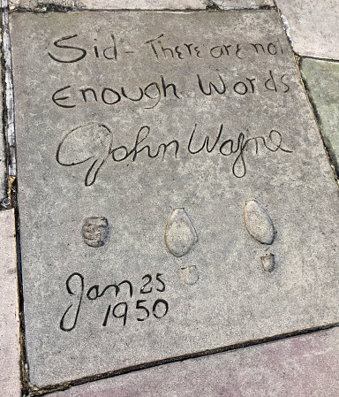 Los Angeles, CA, US - June 8, 2018: The bootprints and fist print of famous actor John Wayne in front of the historic Chinese theater in downtown Hollywood, California.